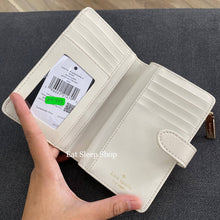 Load image into Gallery viewer, KATE SPADE CAREY MEDIUM COMPACT BIFOLD WALLET IN PARCHMENT (MINOR DENTS AND SCRATCHES)