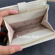 Load image into Gallery viewer, KATE SPADE CAREY MEDIUM COMPACT BIFOLD WALLET IN PARCHMENT (MINOR DENTS AND SCRATCHES)