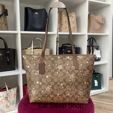 Load image into Gallery viewer, COACH ZIP TOP TOTE IN SIGNATURE CANVAS WITH STAR AND SNOWFLAKE PRINT CN671 IM/KHAKI SADDLE/GOLD MULTI
